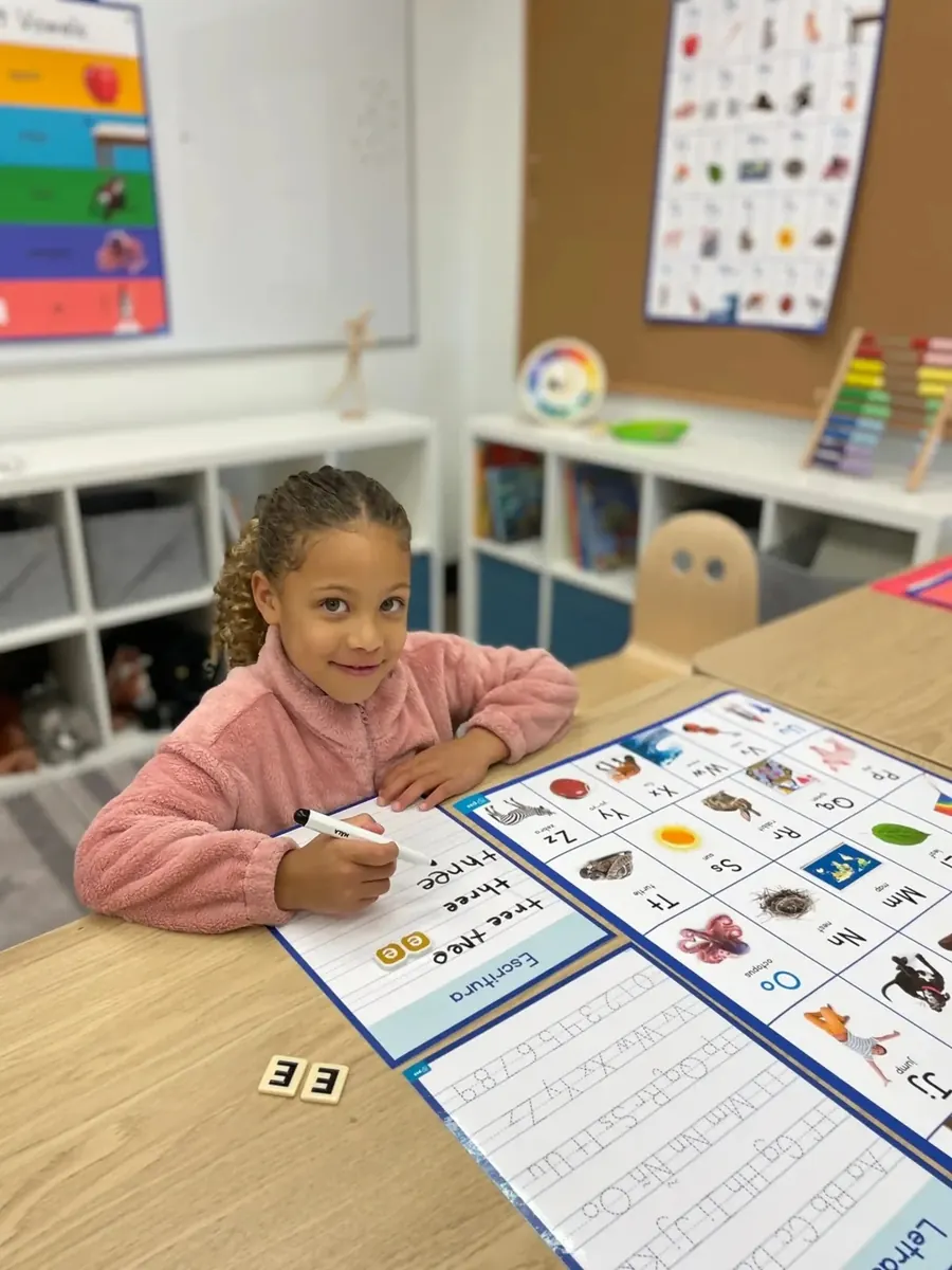 Student using a printed Folio learning poster at her desk